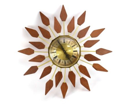 An Anstey &amp; Wilson 'sunburst' or 'starburst' clock, the brass and silvered face with Roman numerals, each teak petal-like