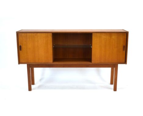 A 1970's British teak bookcase, the central section with a glass shelf, flanked by two sliding doors, on square straight legs