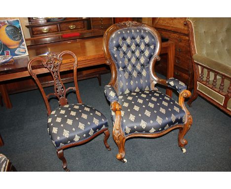 A Victorian mahogany framed button back armchair with carved scrolling detail, together with a nursing chair with pierced vas