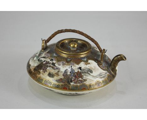 A small Japanese Satsuma teapot, flattened circular form with figural decoration and bamboo handle, character marks to base, 