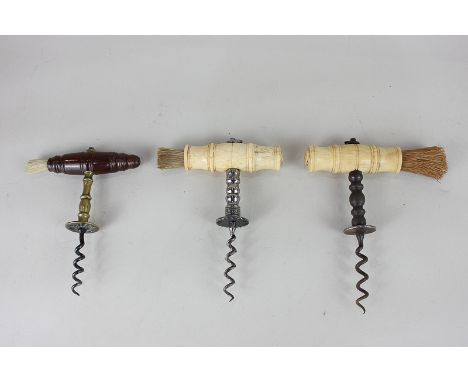A 19th century bone handled corkscrew with serrated button, a wooden handled straight pull corkscrew, and an imitation bone h
