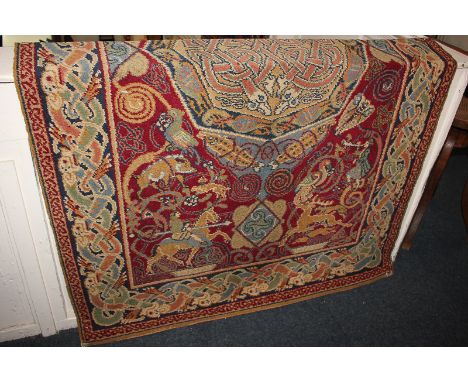 An Arts and Crafts style wool rug, Celtic knot medallion centre on red ground with knights on horseback, within ribbon border