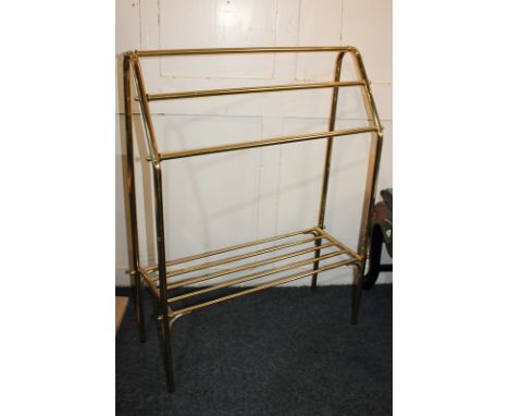 A brass clothes rack with three rails and shelf, 73cm