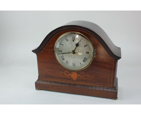 An Edwardian inlaid mahogany domed case mantel clock with 5 1/2 inch dial, stepped base and gilt metal button feet, 34cm