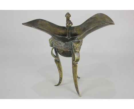 A Chinese bronze ritual tripod wine vessel, 19.5cm high