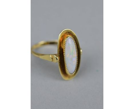 AN EARLY MID 20TH CENTURY OPAL SINGLE STONE RING, opal measuring approximately 15mm x 6mm, bead set to a plain polished head,