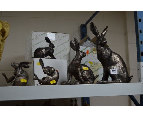 A PAUL JENKINS BRONZED CERAMIC SCULPTURE OF A HARE SCRATCHING BEHIND AN EAR, together with four Frith bronzed sculptures of h