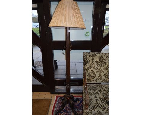 AN EARLY 20TH CENTURY MAHOGANY STANDARD LAMP, column style upright on four outward splayed legs, with a shade