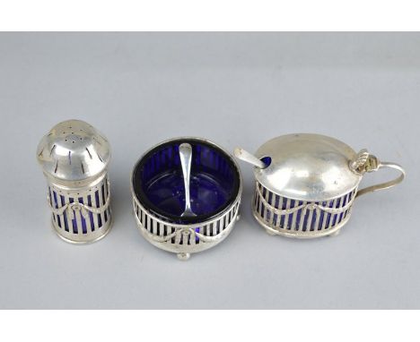 A GEORGE V MATCHED SILVER CRUET SET, in the garland style with openwork rectangular frame and swag decoration, raised on ball