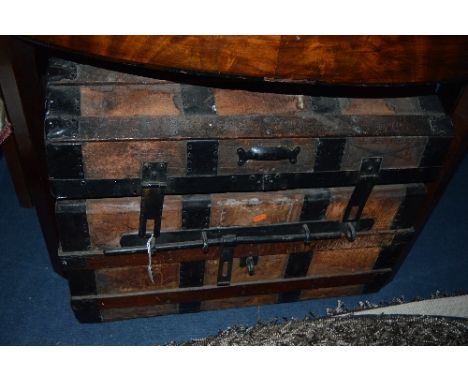 A METAL BANDED DOMED TOPPED TRUNK (distressed)