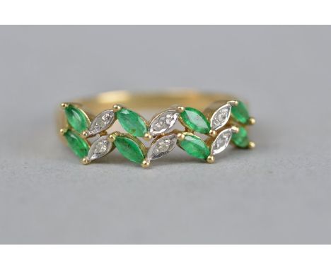 AN EMERALD AND DIAMOND TWO ROW 9CT YELLOW GOLD RING, the marquise shaped emeralds alternate diamond set, ring size O, approxi