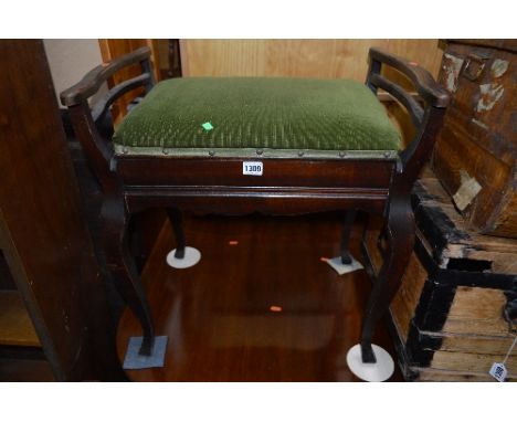 AN EDWARDIAN MAHOGANY PIANO STOOL, with rise and fall interior and a tin trunk (s.d) (2)