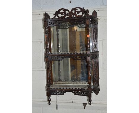 A 20TH CENTURY MAHOGANY BEVELLED EDGE THREE TIER WALL SHELF, with pierced fretwork detail (sd)