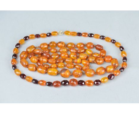 A CLARIFIED GRADUATED AMBER BEAD NECKLACE, together with a faceted orange opal type and red plastic bead necklace (2)