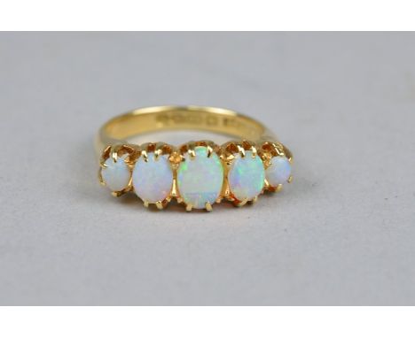 A MID 20TH CENTURY HALF HOOP OPAL RING, opals graduating in size, ring size N, hallmarked 18ct gold, Birmingham 1945, approxi