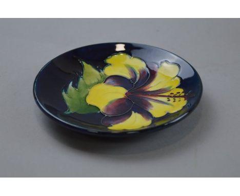 A MOORCROFT POTTERY TRINKET DISH, 'Hibiscus' pattern on blue ground, impressed marks to base