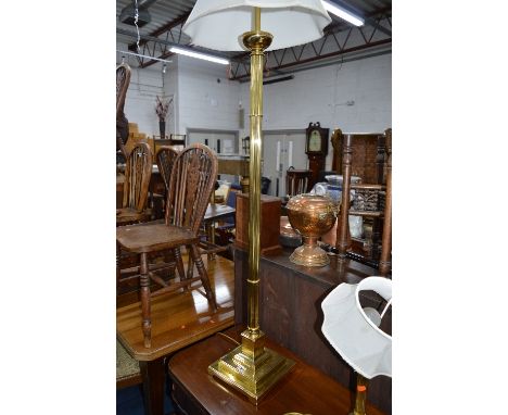 A BRASS STANDARD LAMP, with shade, brass table lamp, circular two tier trolley with a stainless steel frame, three wicker bas