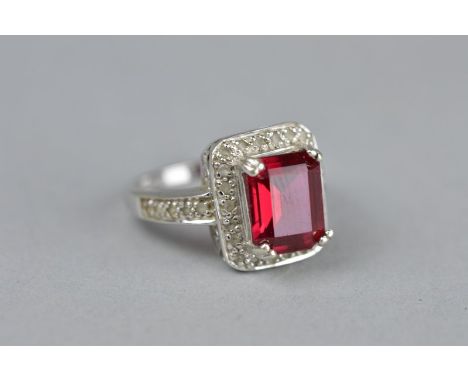 A SYNTHETIC RUBY AND WHITE STONE RECTANGULAR 9CT WHITE GOLD CLUSTER RING, ring size N, approximate gross weight 51 grams