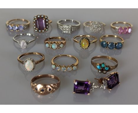 An assortment of thirteen gem-set rings in white and yellow gold together with 4 pair of gem-set earrings, all hallmarked/sta