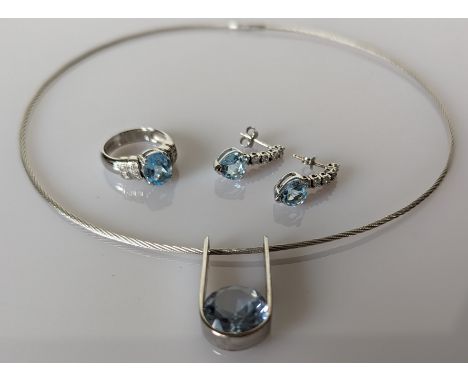 A custom made pendant set with a round mixed-cut pale blue topaz, 14mm diameter, set to white wire U-shape frame drop, suspen