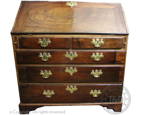 A George III style mahogany bureau, with fall enclosing a fitted interior, above two short and three graduated long drawers, 