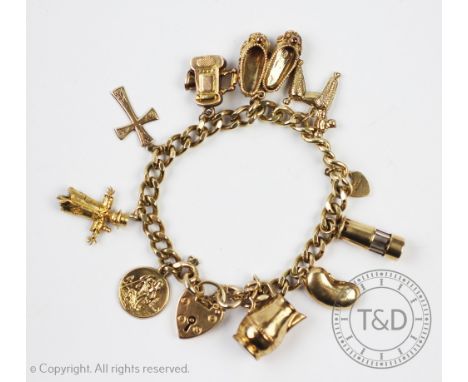 A 9ct yellow gold charm bracelet, the curb link bracelet hung with ten charm, to include; a miners lamp, a scarecrow, a St Ch