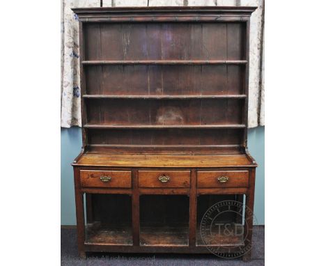 A George III oak dresser, raised back with moulded cornice and three shelves, above three short drawers and pot shelf, on sti