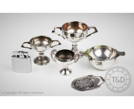 A Scottish silver quaich shaped salt, Edinburgh 1904, a small silver trophy, two further EPNS trophies, a miniature mantel cl