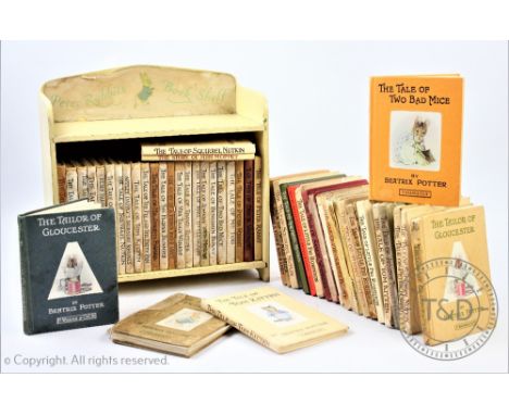 A collection of fifty Beatrix Potter book in a 'Peter Rabbits Book Shelf', various editions - condition varies from fair to p