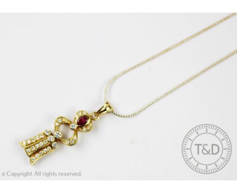 A ruby and diamond pendant and chain, of double gourd shape and within a diamond set surround, all set in yellow metal, indis