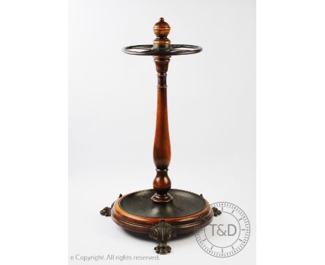 A Victorian style walnut stick stand, the central turned column supported by a circular drip tray base raise on four paw feet