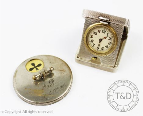 A silver folding travel bedside timepiece, Birmingham 1933, with engine turned decoration, the circular dial with Arabic nume