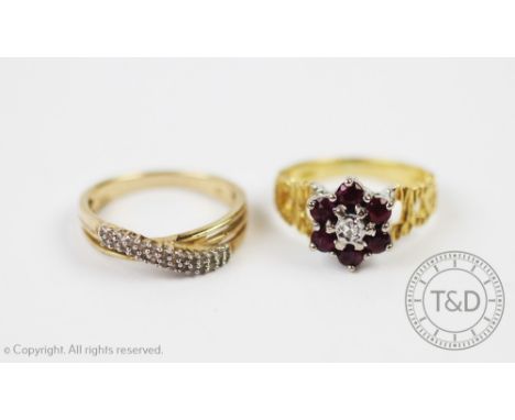 A ruby and diamond circular cluster ring, all claw set in white metal to the textured yellow gold hoop, all set in 18ct gold,