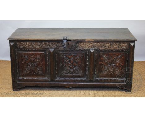 A 17th century and later carved oak coffer, with panelled front, on bracket feet, 64cm H x 142cm W x 59cm D