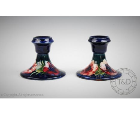 A pair of Moorcroft Anemnone pattern candlesticks, 9cm high, and Beswick stag, doe and fawn (5) (at fault) CONDITION REPORT: 