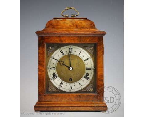 An Elliot walnut quarter chiming mantel clock retailed by Ollivant &amp; Botsford of Manchester, the square brass face with s