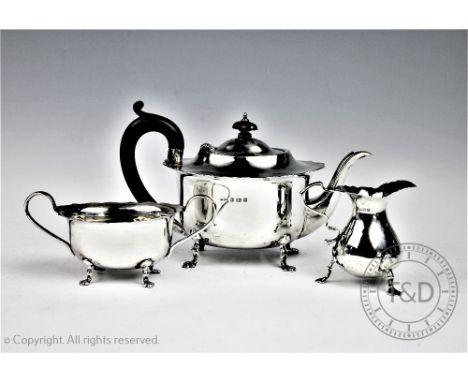 An assembled three pieces silver tea service comprising; a teapot, B Street &amp; Co, Birmingham 1929, 14.5cm high, a twin ha