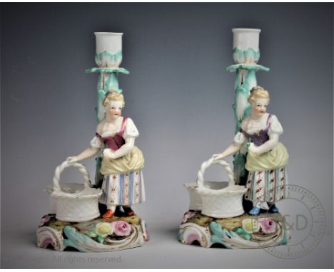 A pair of 20th century Helene Wolfsohn figural candlesticks, designed as a flower picker on a scroll base, blue glazed mark t