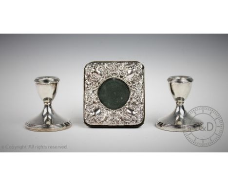 A pair of silver short candlesticks, Bishton's Ltd, Birmingham 1969, a plain polished reeded design, 8cm high and a silver mo