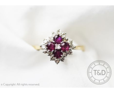 A quatrefoil ruby and diamond ring, designed as four rubies within a diamond set surround, all set in white and yellow 9ct go