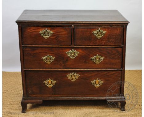 A George III and later oak and pine chest, with two short and two long drawers, on ogee bracket feet, 85cm H x 95cm W x 57cm 