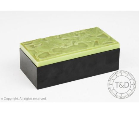An Art Deco box and cover, the pressed resin cover decorated with a neoclassical hunting scene enclosing an internal removabl