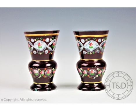 A pair of Bohemian ruby flashed glass vases, painted with flowers, 16cm high