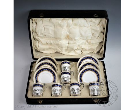A Royal Worcester silver mounted twelve piece coffee service, the silver cup holders London 1917, with presentation inscripti
