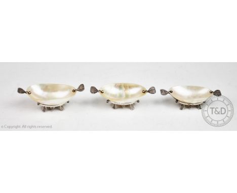 A set of three Russian white metal mounted mother of pearl caviar servers, each with filigree twin handles and raised on four