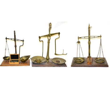 Three Brass Beam Scales, all on mahogany bases, including one by Avery, together with weights 