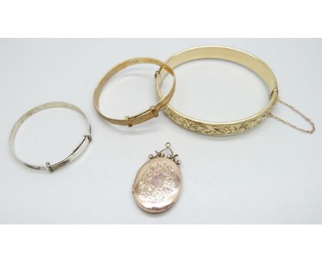 A 9ct gold back and front locket, a silver bangle, and two rolled gold bangles