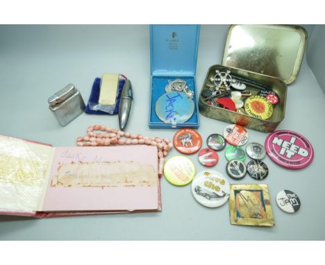 A collection of badges, a Colibri lighter, pendants, etc. and an autograph book containing Engelbert Humperdinck's signature,