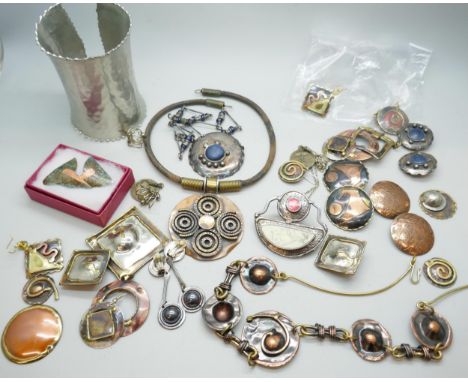 A collection of brutalist jewellery including a necklace and earring set and a cuff bangle 