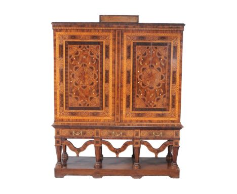  A Dutch walnut and seaweed marquetry press cupboard,   circa 1750, the moulded cornice above a pair of profusely decorated d